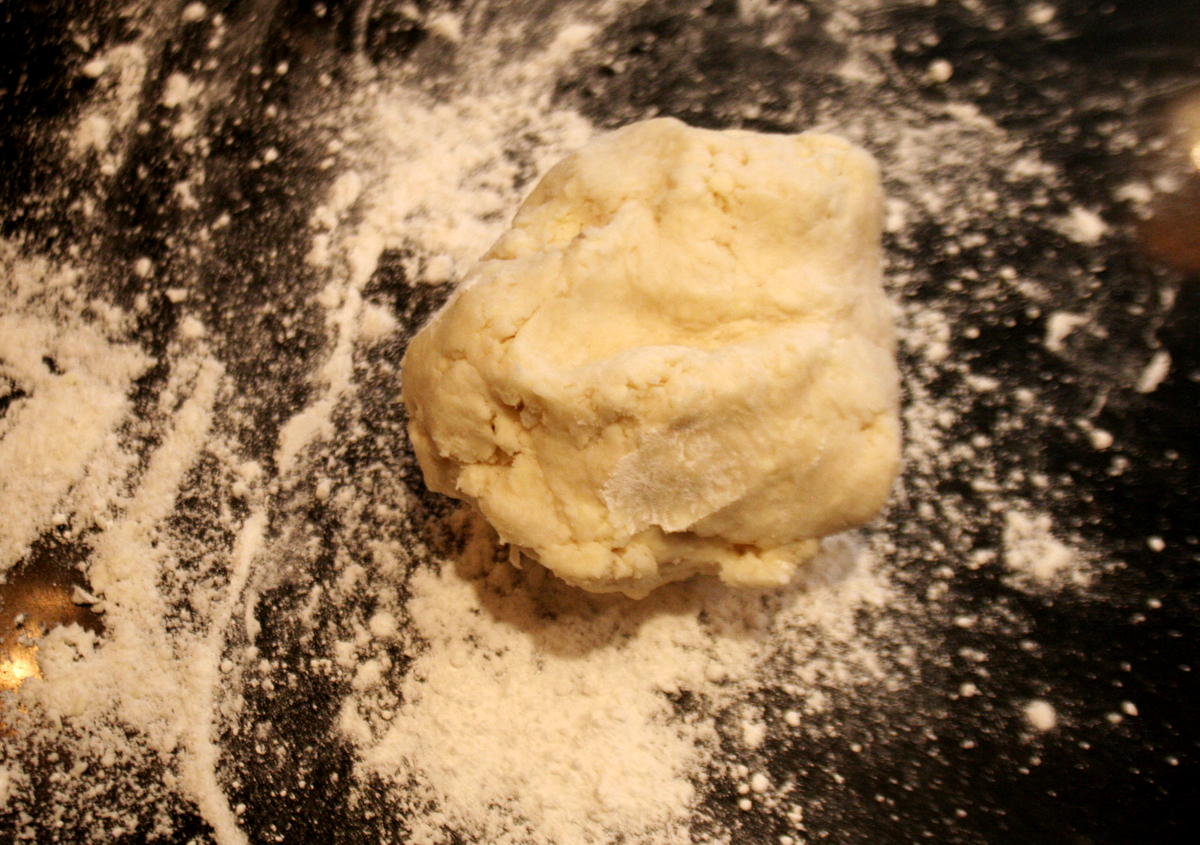 Patting the pie dough into shape