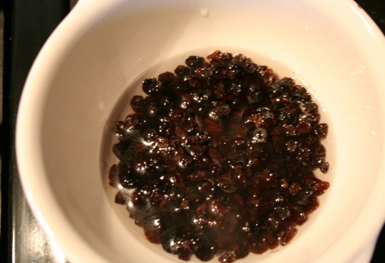 Soaking dried currants for hot cross buns.