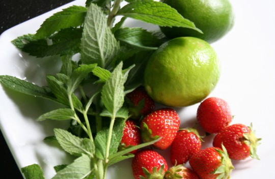 Ingredients for a Strawberry Mojito - lime, mint and strawberries