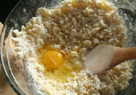 Mixing in the egg, flour and salt to grated potatoes