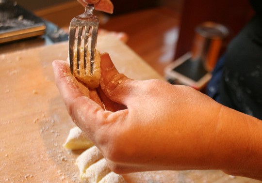 Rolling grooves into potato gnocchi with fork